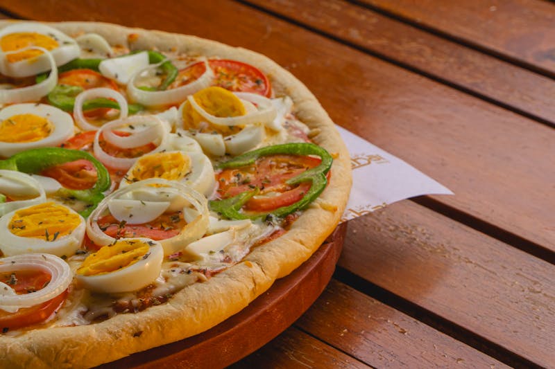 Four seasons signature pizza divided into four sections